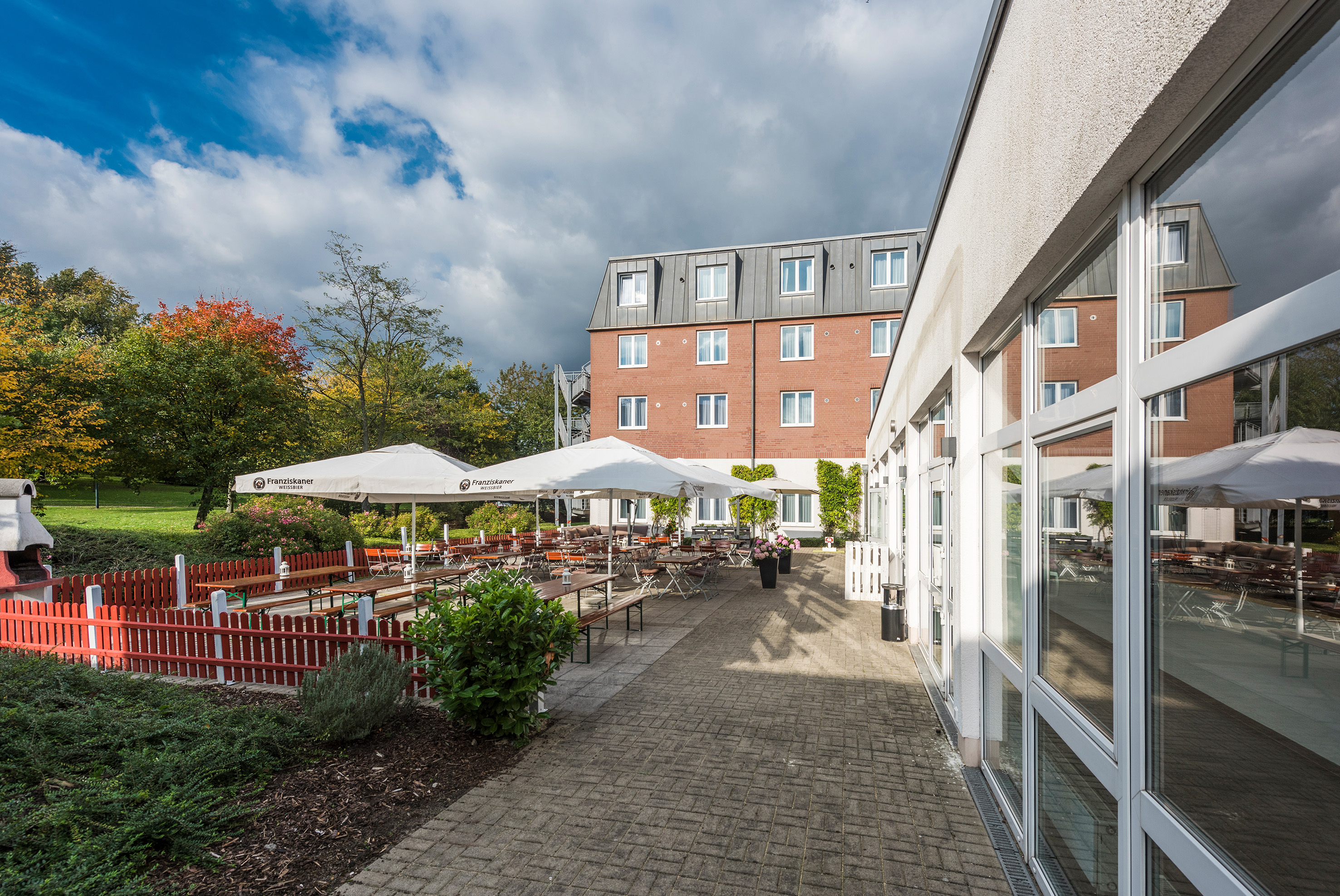 a building with a patio and umbrellas