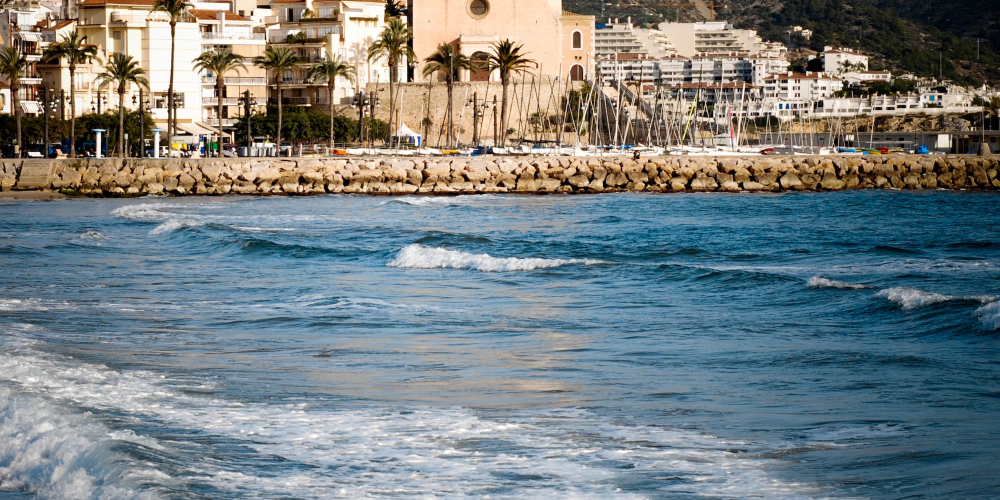 a body of water with a body of water and a building in the background