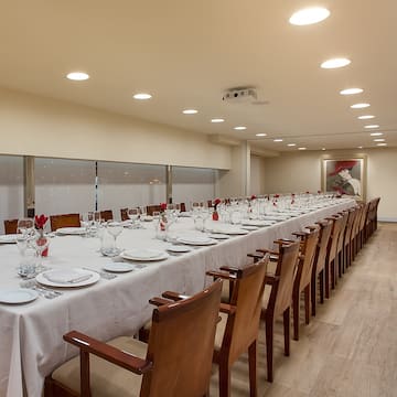 a long table with plates and glasses on it