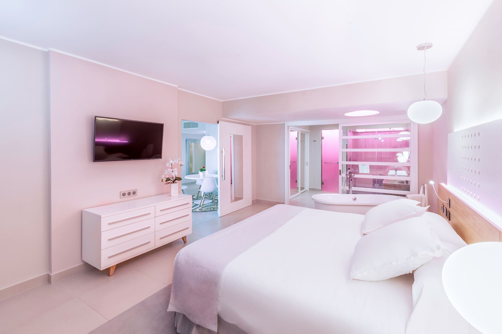 a bedroom with a large bed and a bathtub