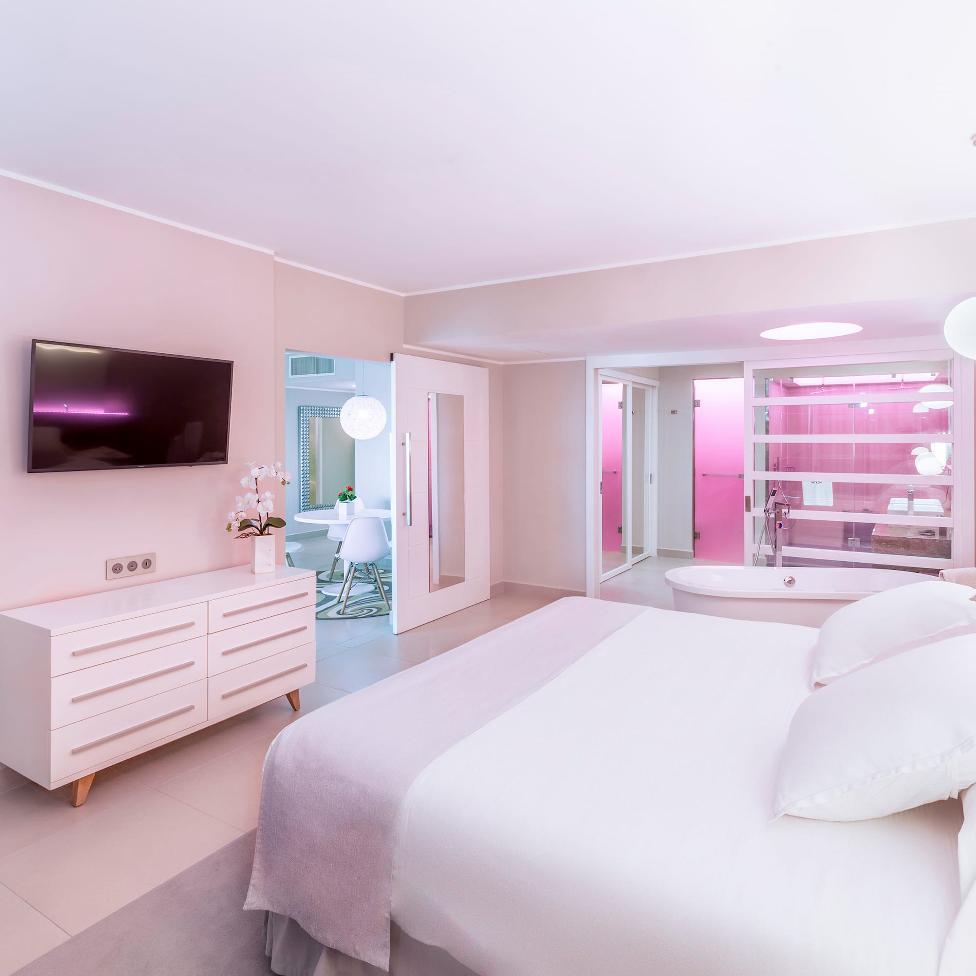 a bedroom with a large bed and a bathtub