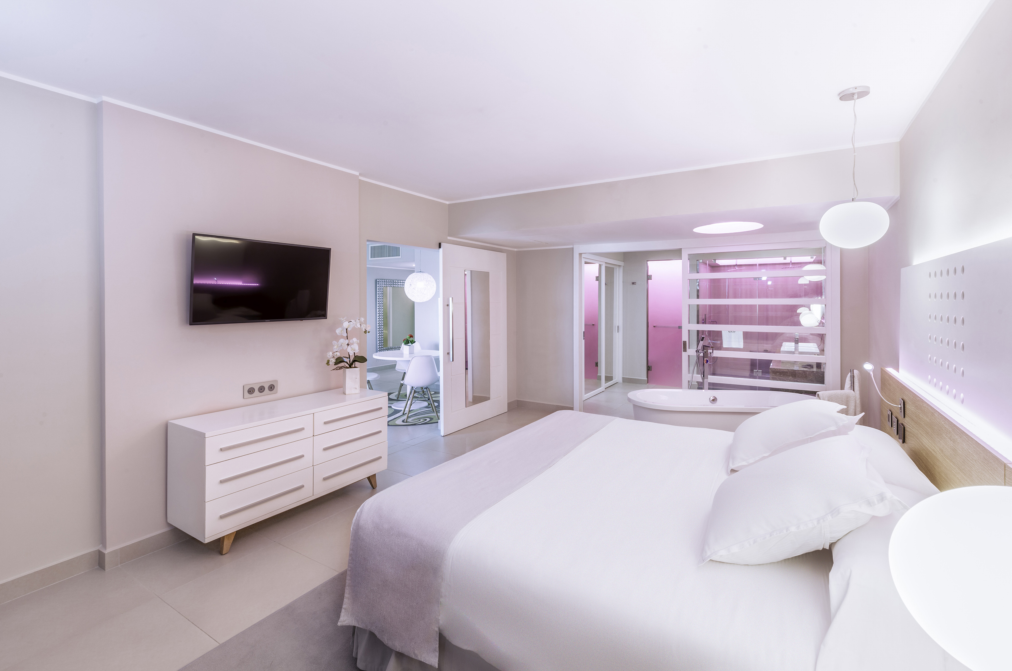 a bedroom with a large bed and a bathtub