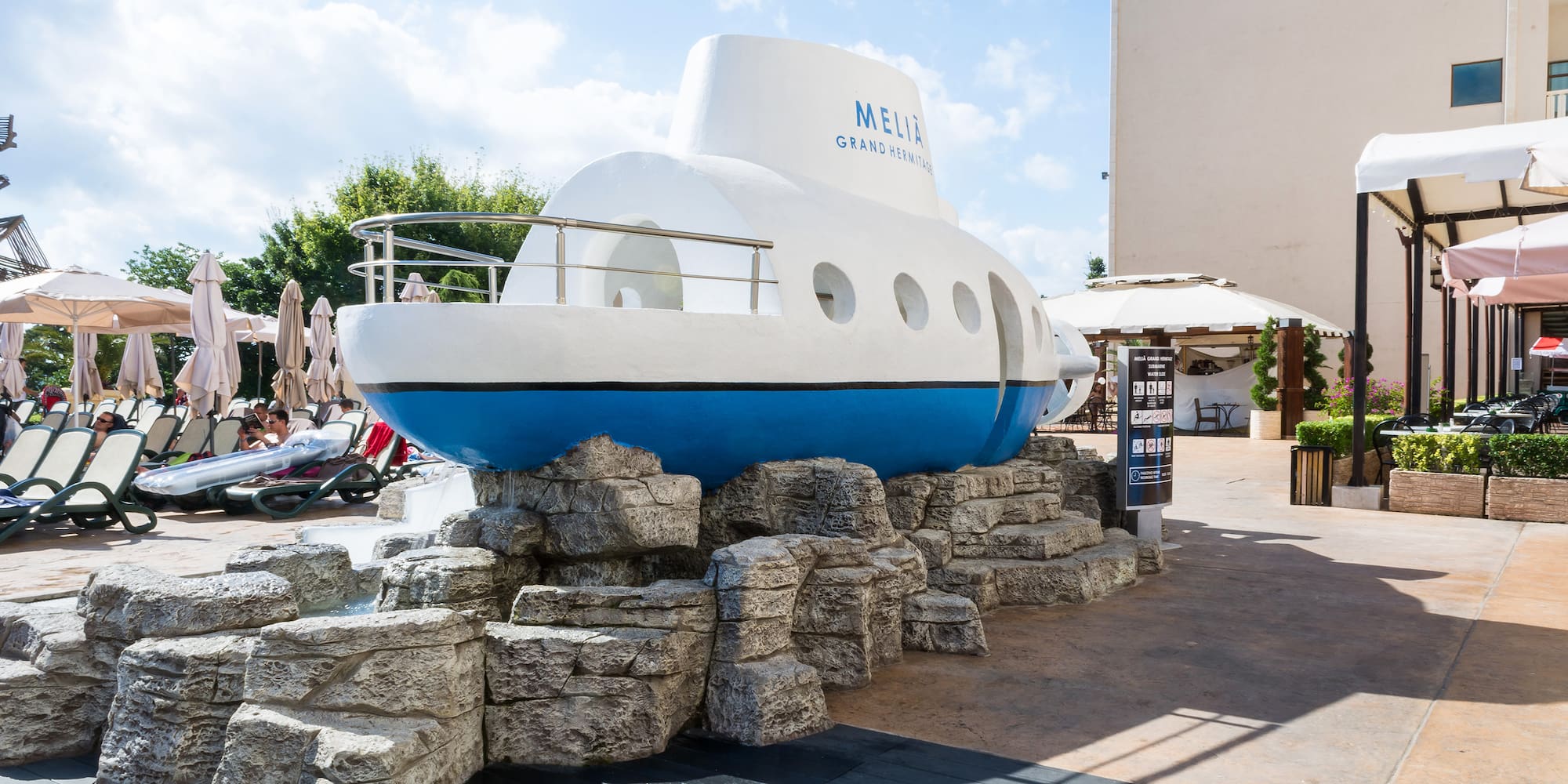 a submarine statue on rocks