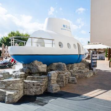 a submarine statue on rocks