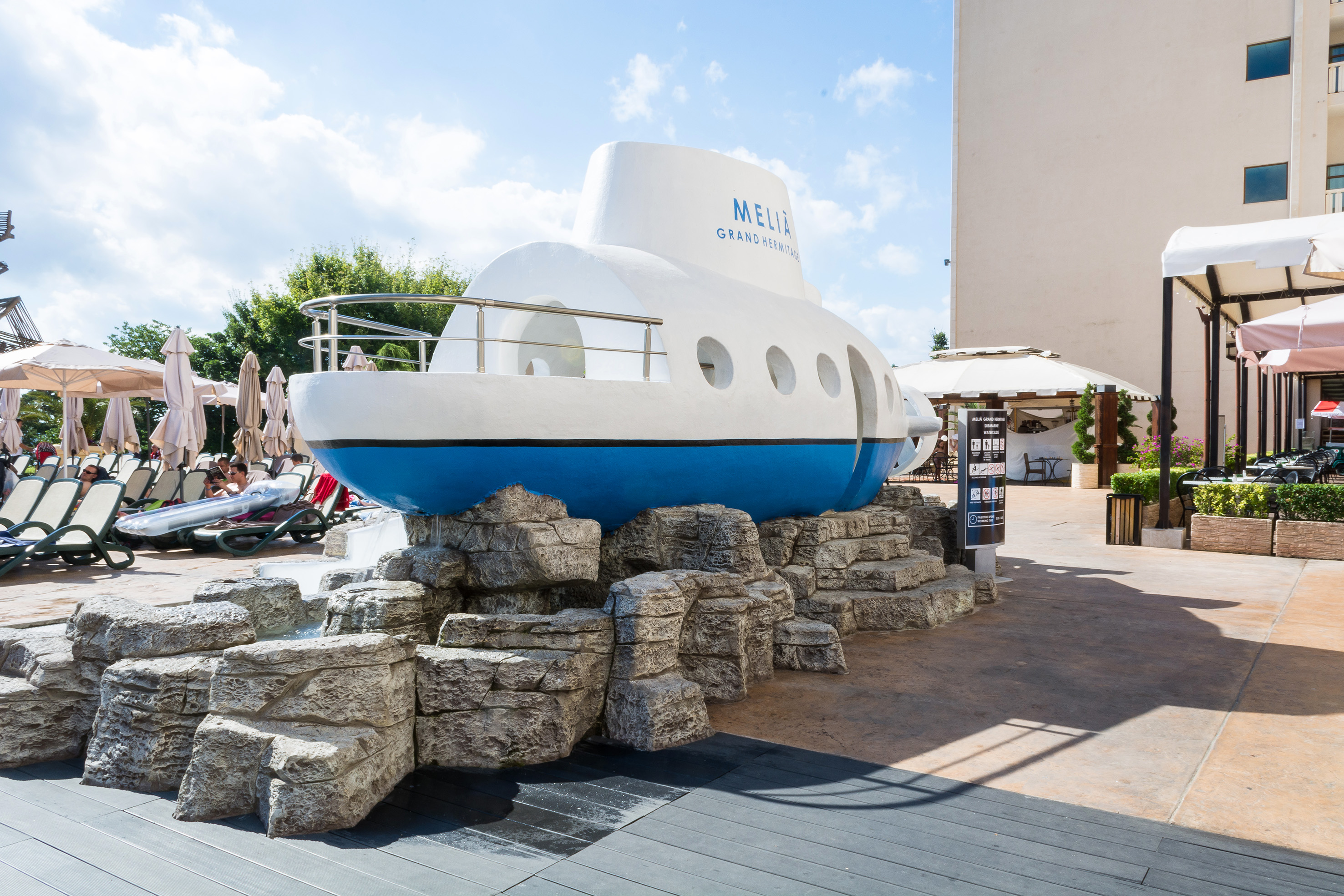 a submarine statue on rocks