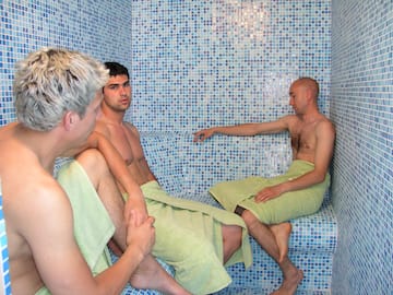 a group of men in a sauna