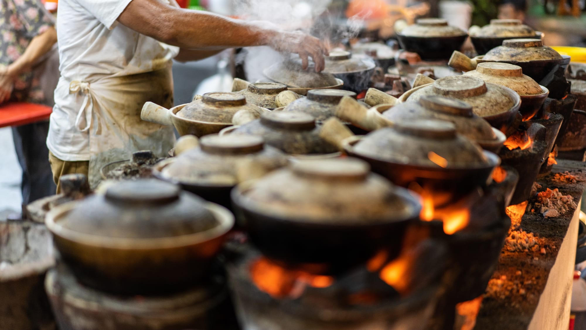 a person cooking food on a fire