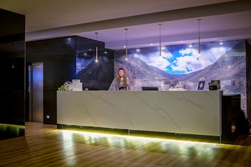a woman standing at a reception desk