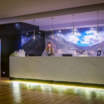 a woman standing at a reception desk
