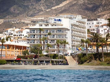 a beach with buildings and trees