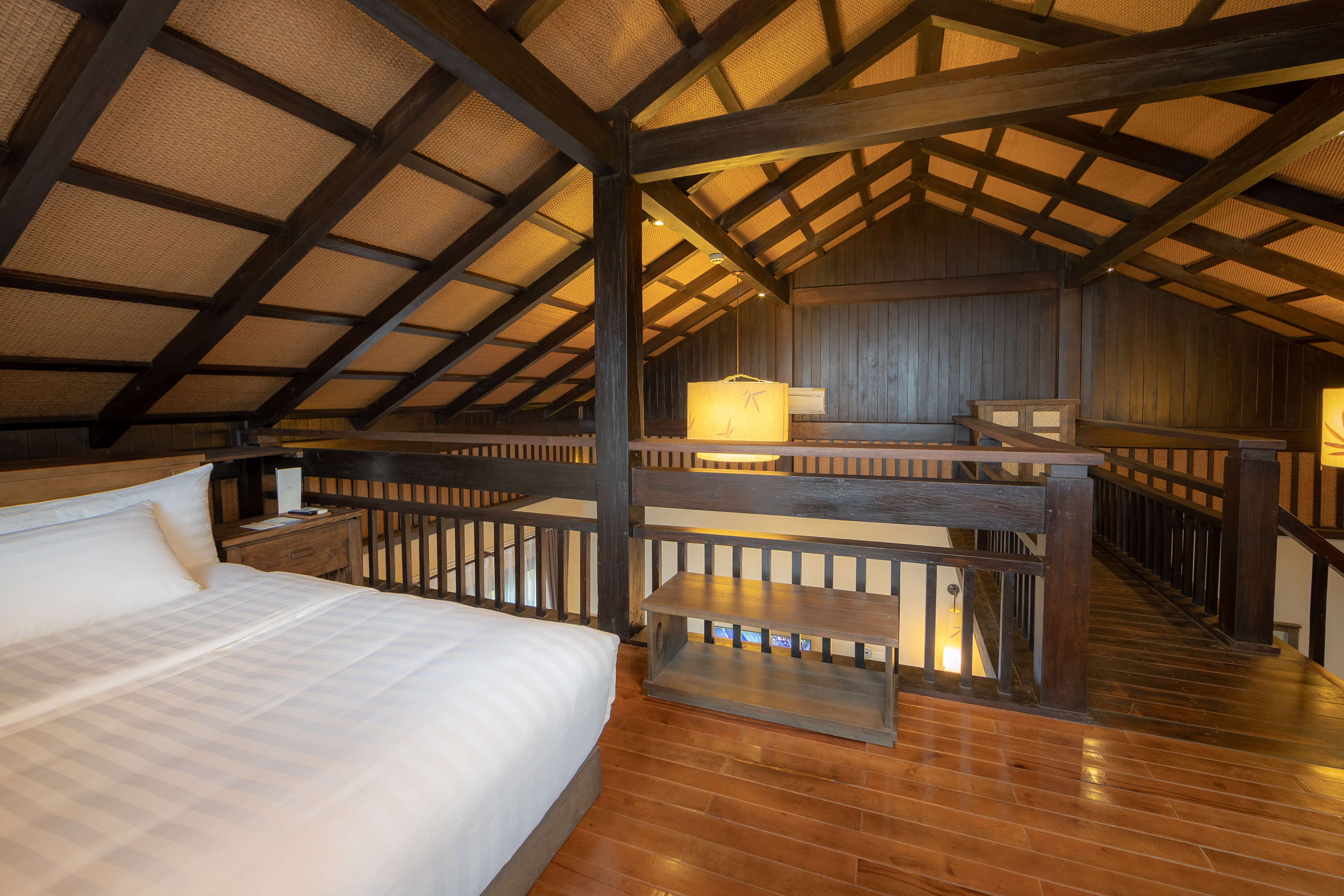 a bedroom with a wood floor and a wood floor