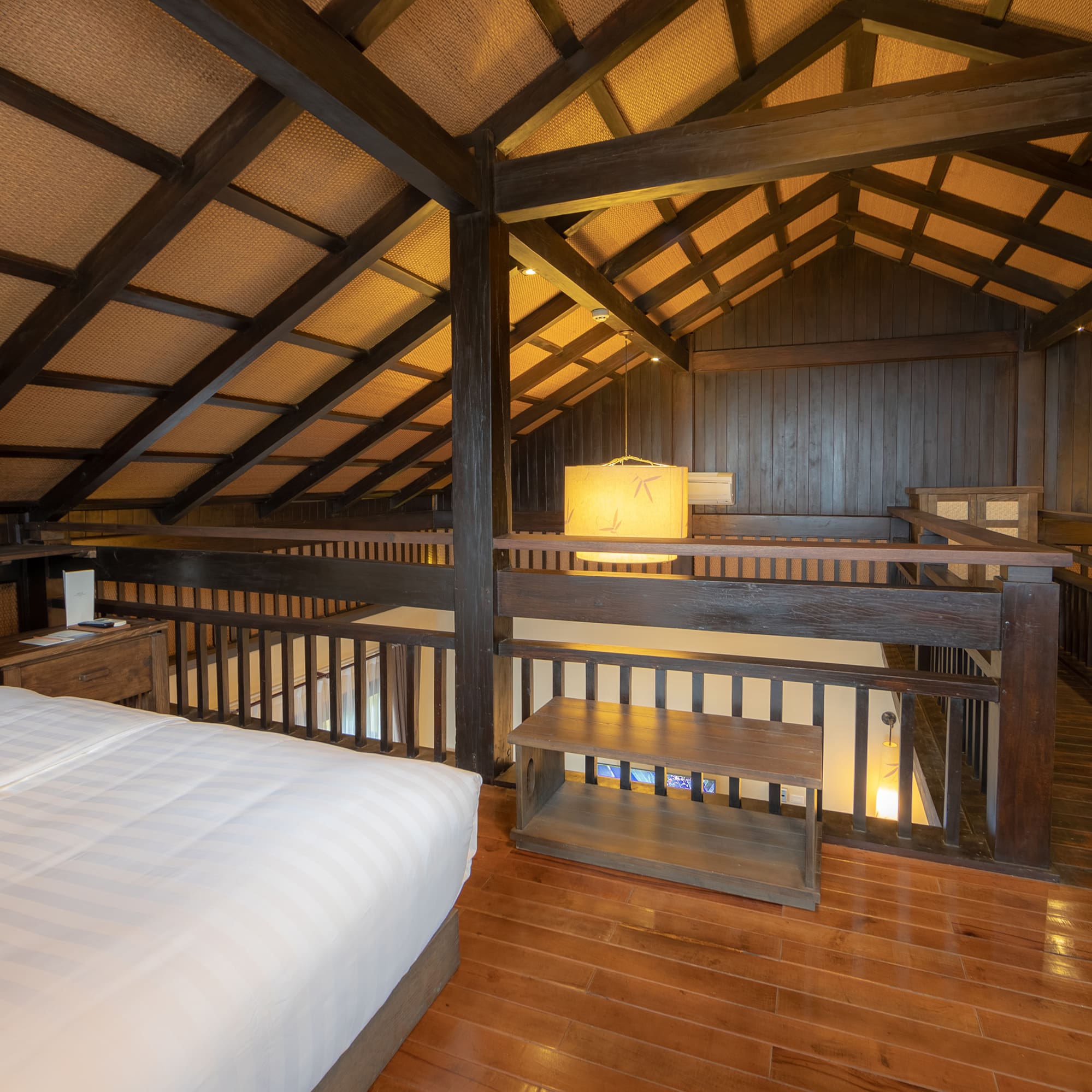 a bedroom with a wood floor and a wood floor