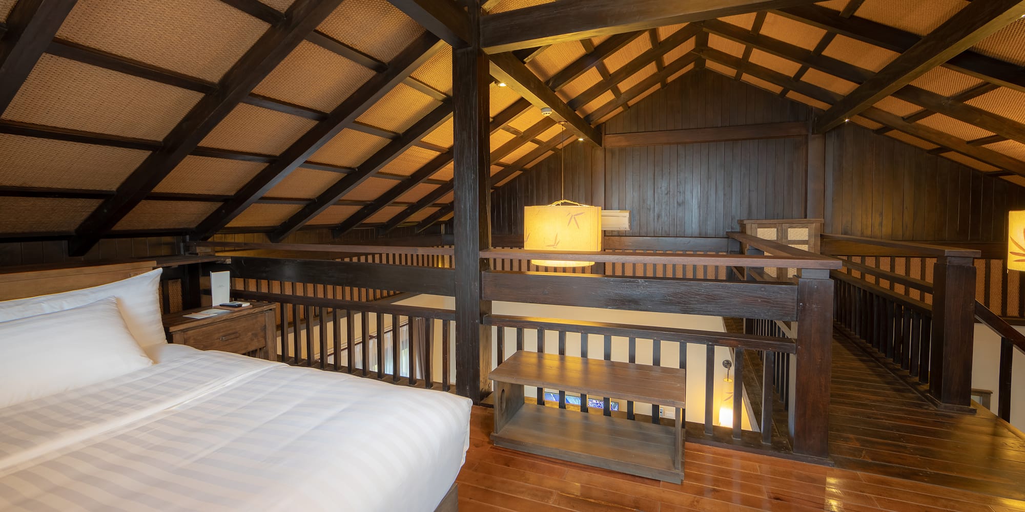 a bedroom with a wood floor and a wood floor