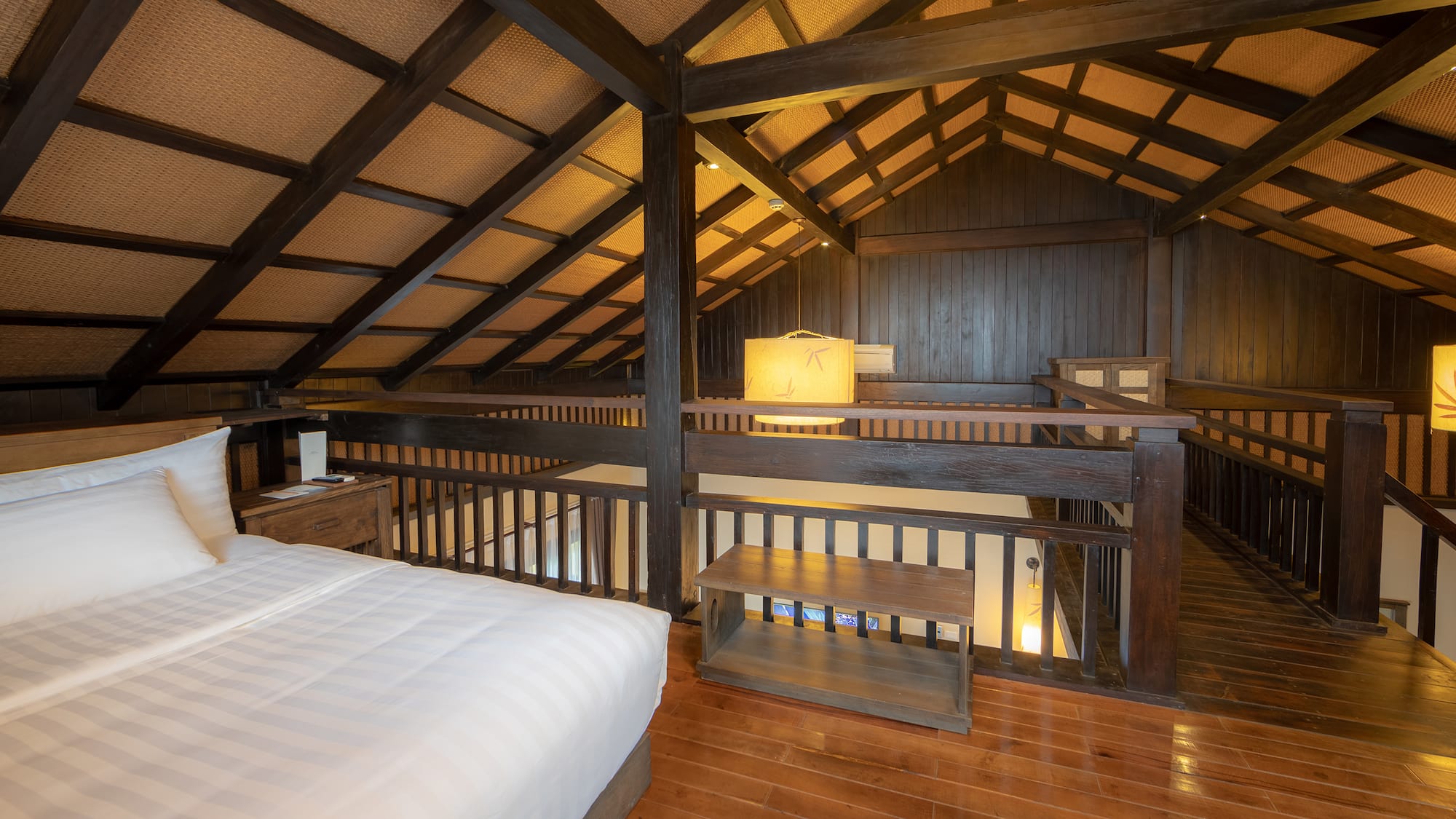 a bedroom with a wood floor and a wood floor