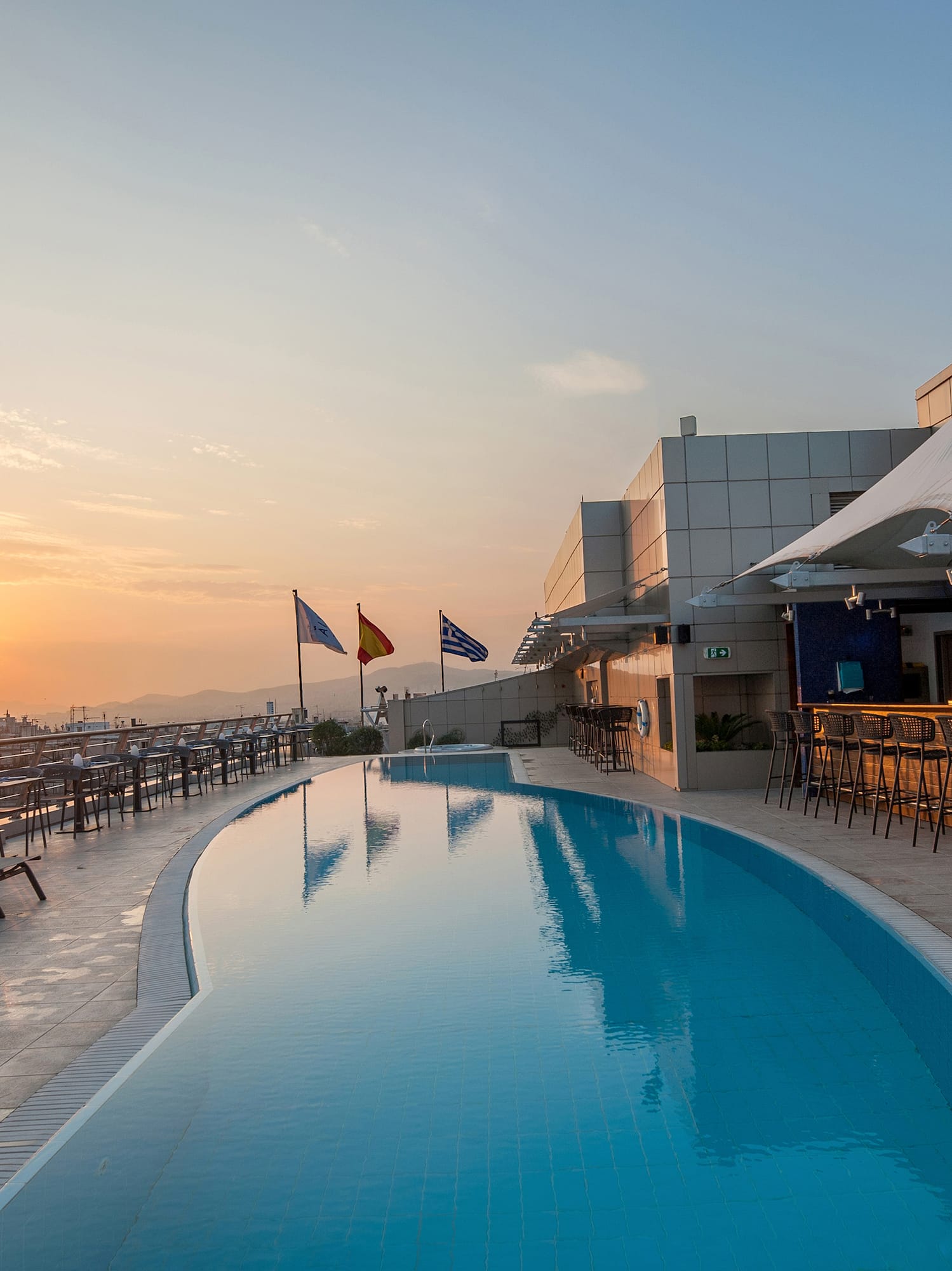 a pool with chairs and tables around it