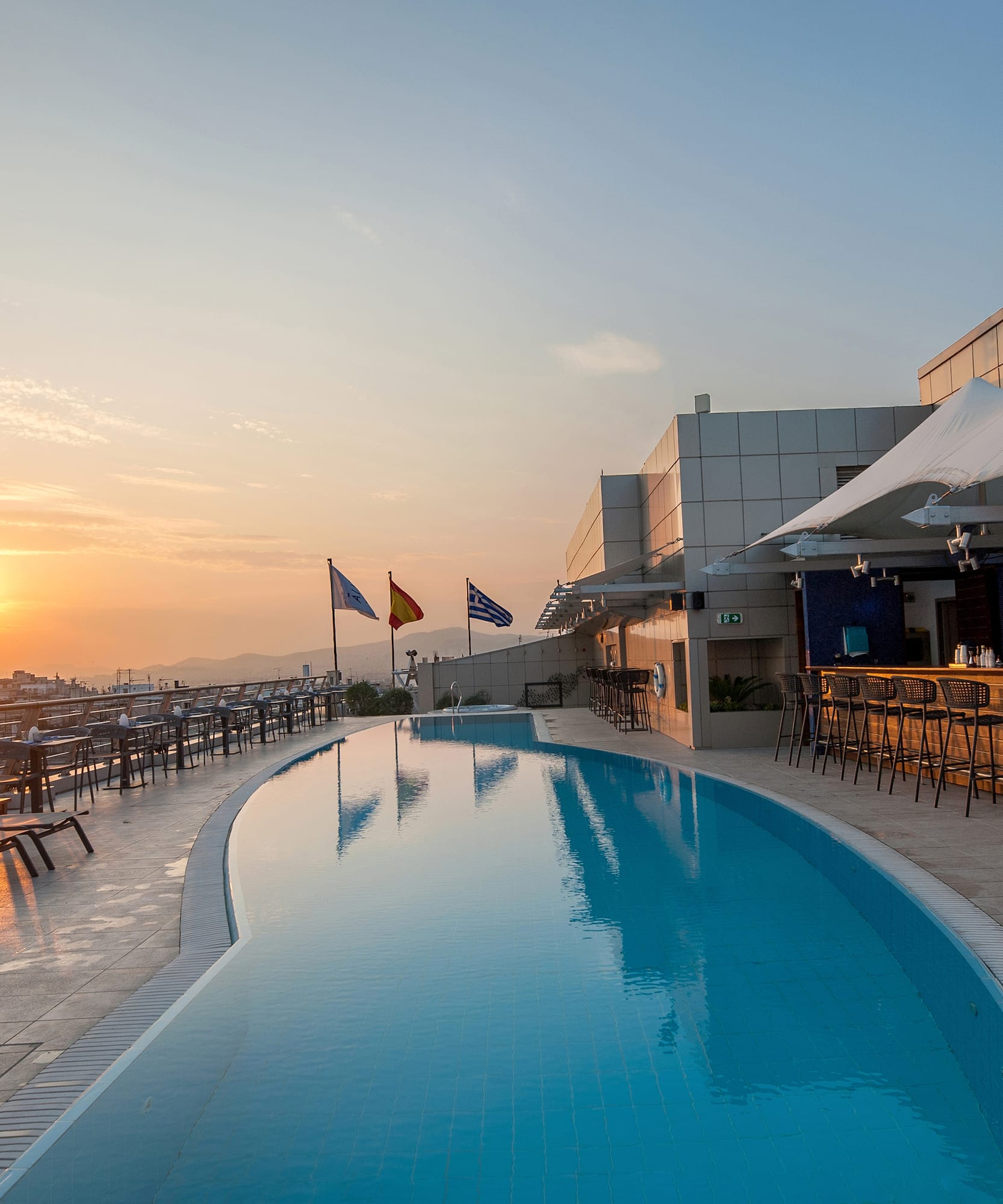 a pool with chairs and tables around it