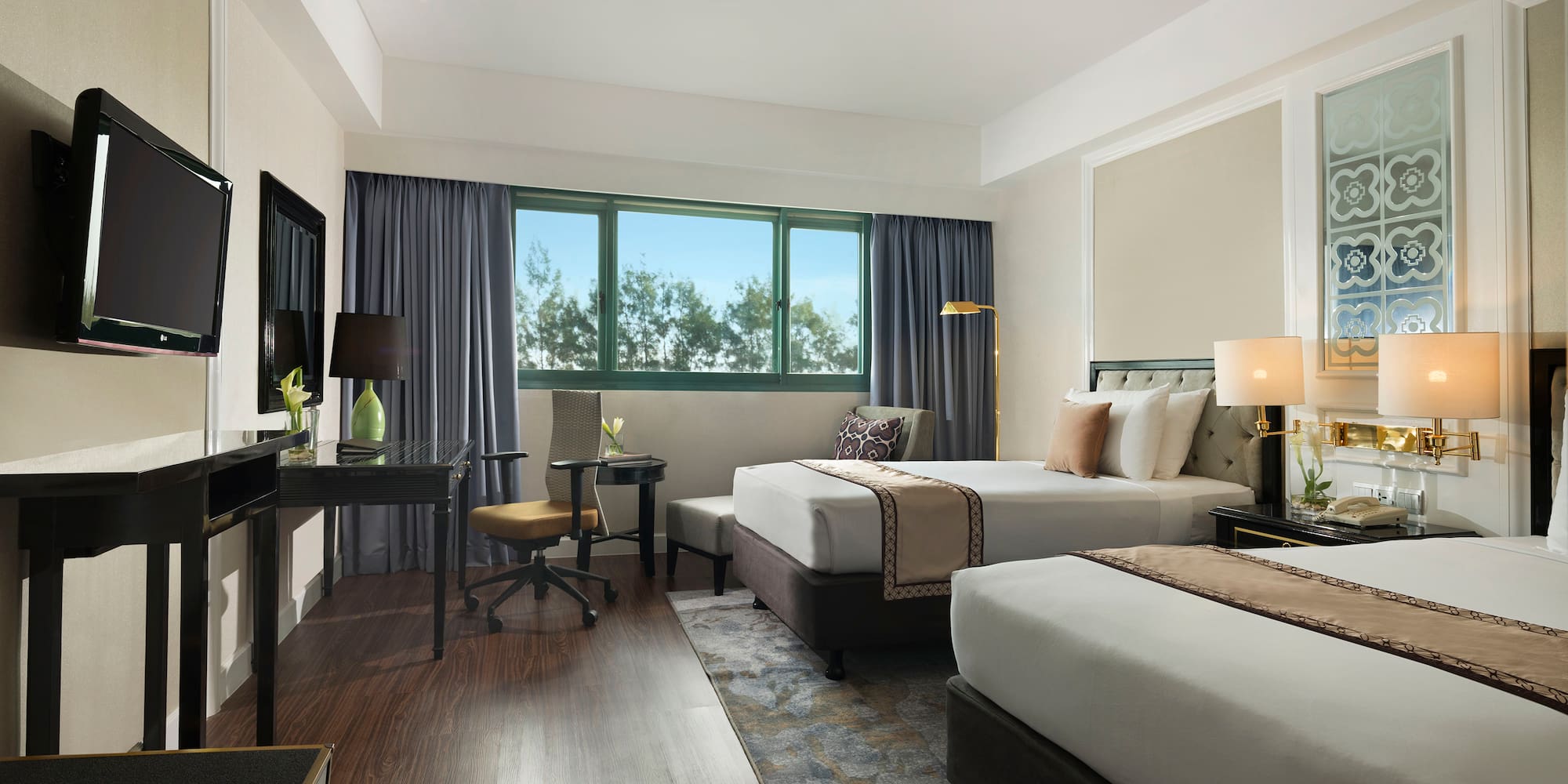 a room with two beds and a desk