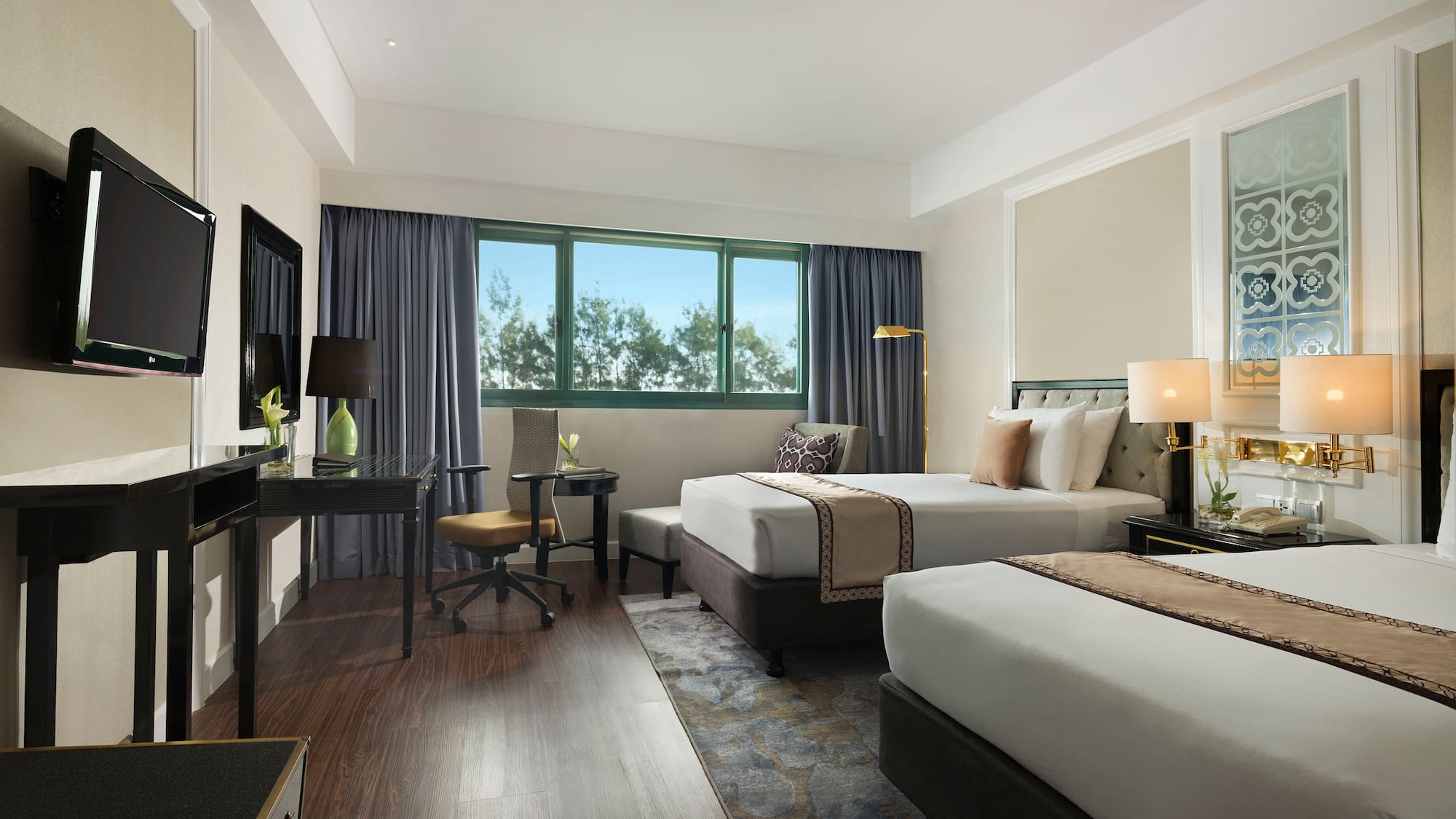 a room with two beds and a desk