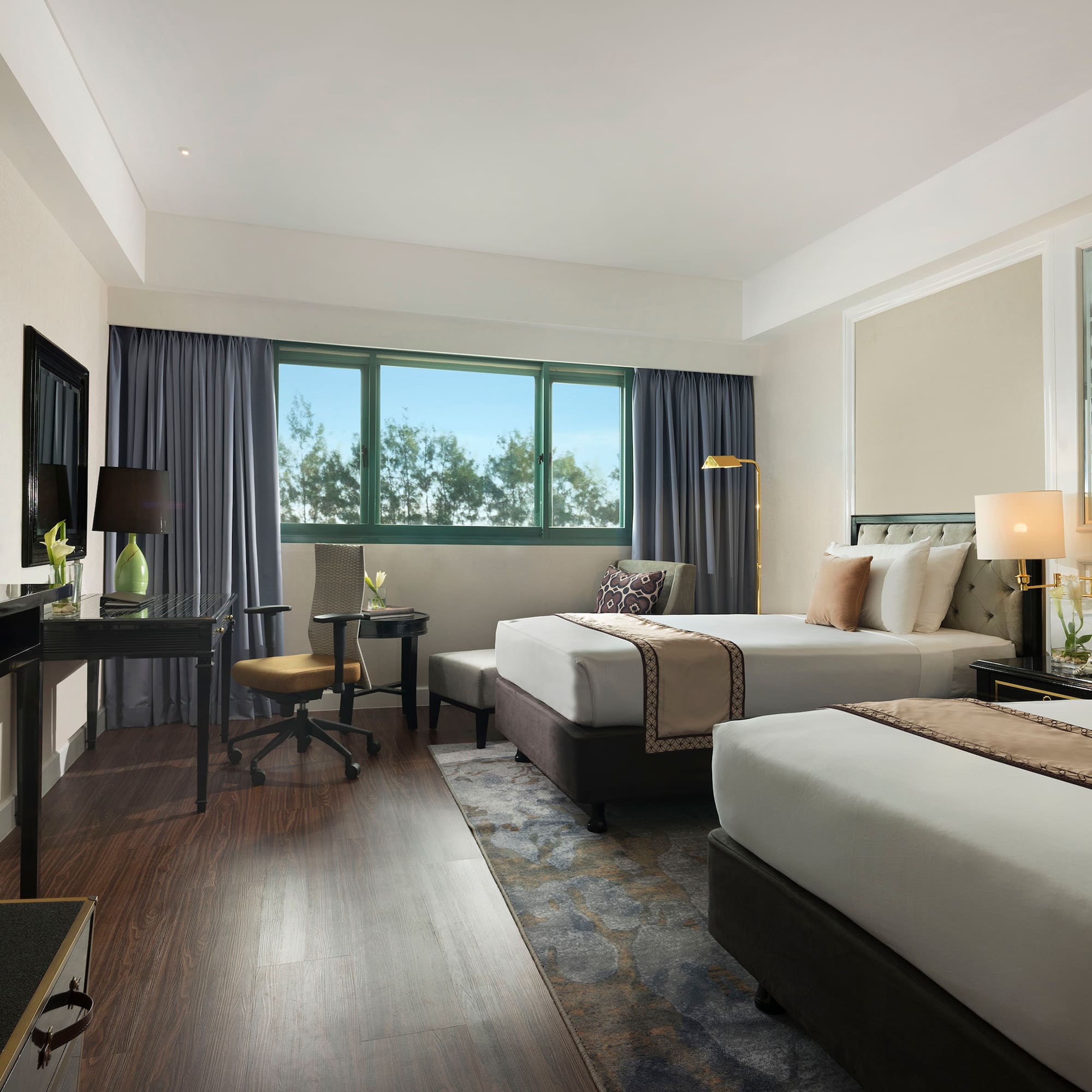 a room with two beds and a desk