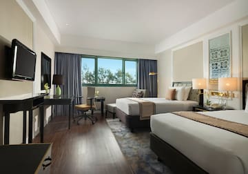 a room with two beds and a desk