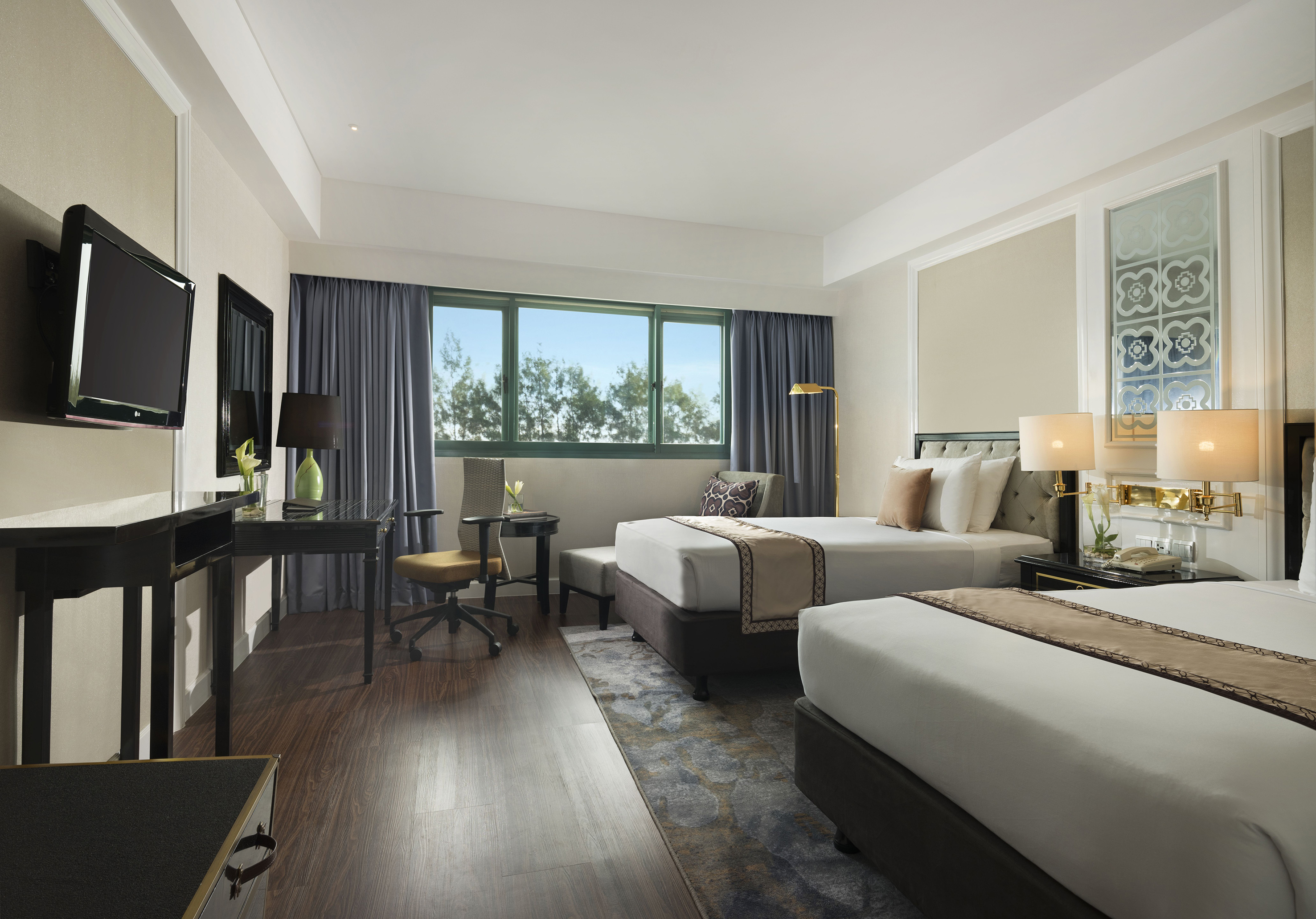 a room with two beds and a desk