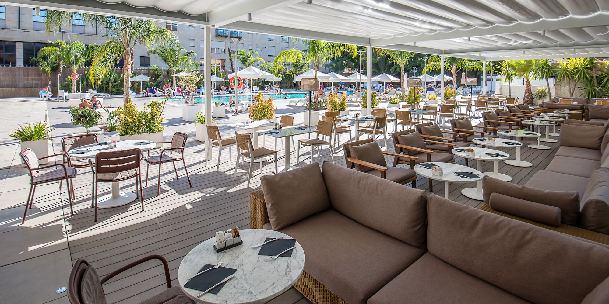 a patio with tables and chairs and umbrellas