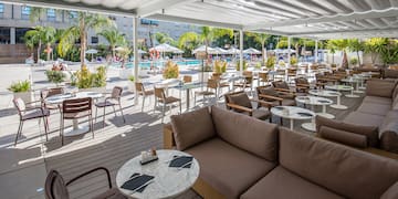 a patio with tables and chairs and umbrellas
