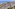 Sunny Mediterranean coastal resort: aerial view of hotels, pools, and beach.