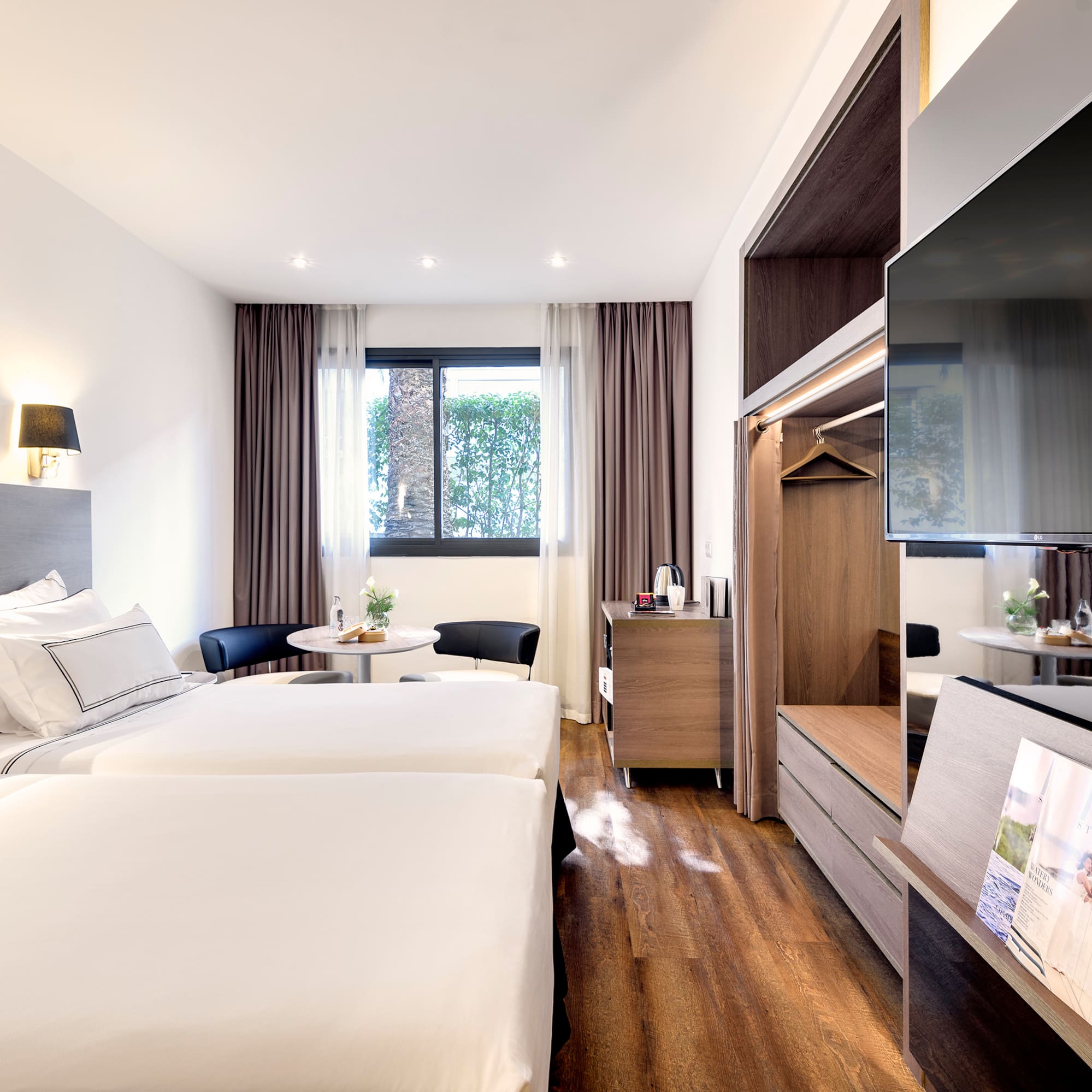 a room with two beds and a television