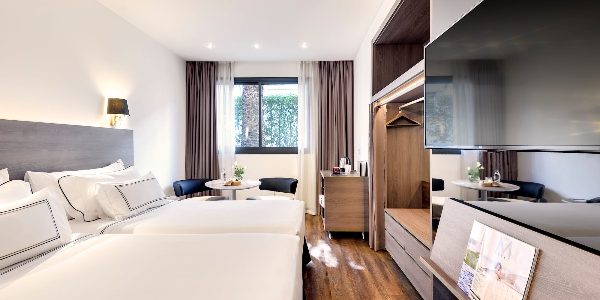 a room with two beds and a television