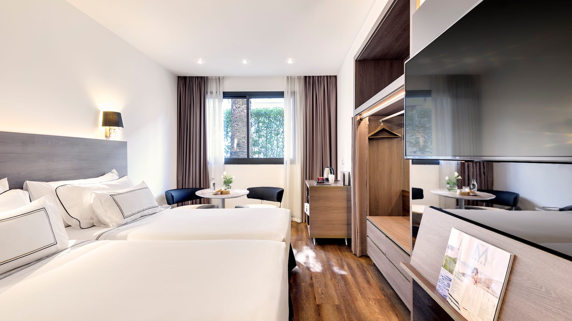 a room with two beds and a television