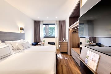 a room with two beds and a television