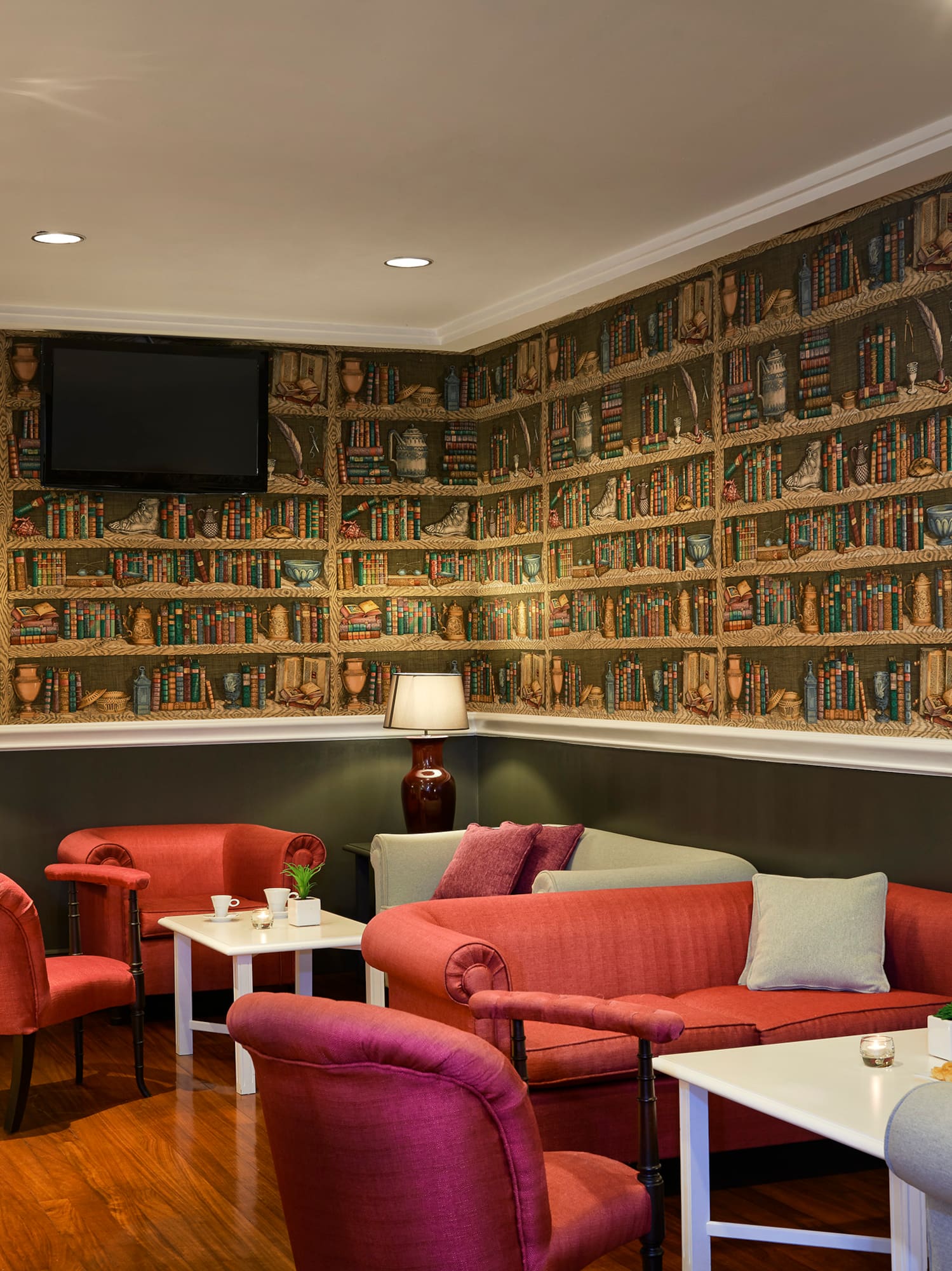 a room with a wall of books and a couch