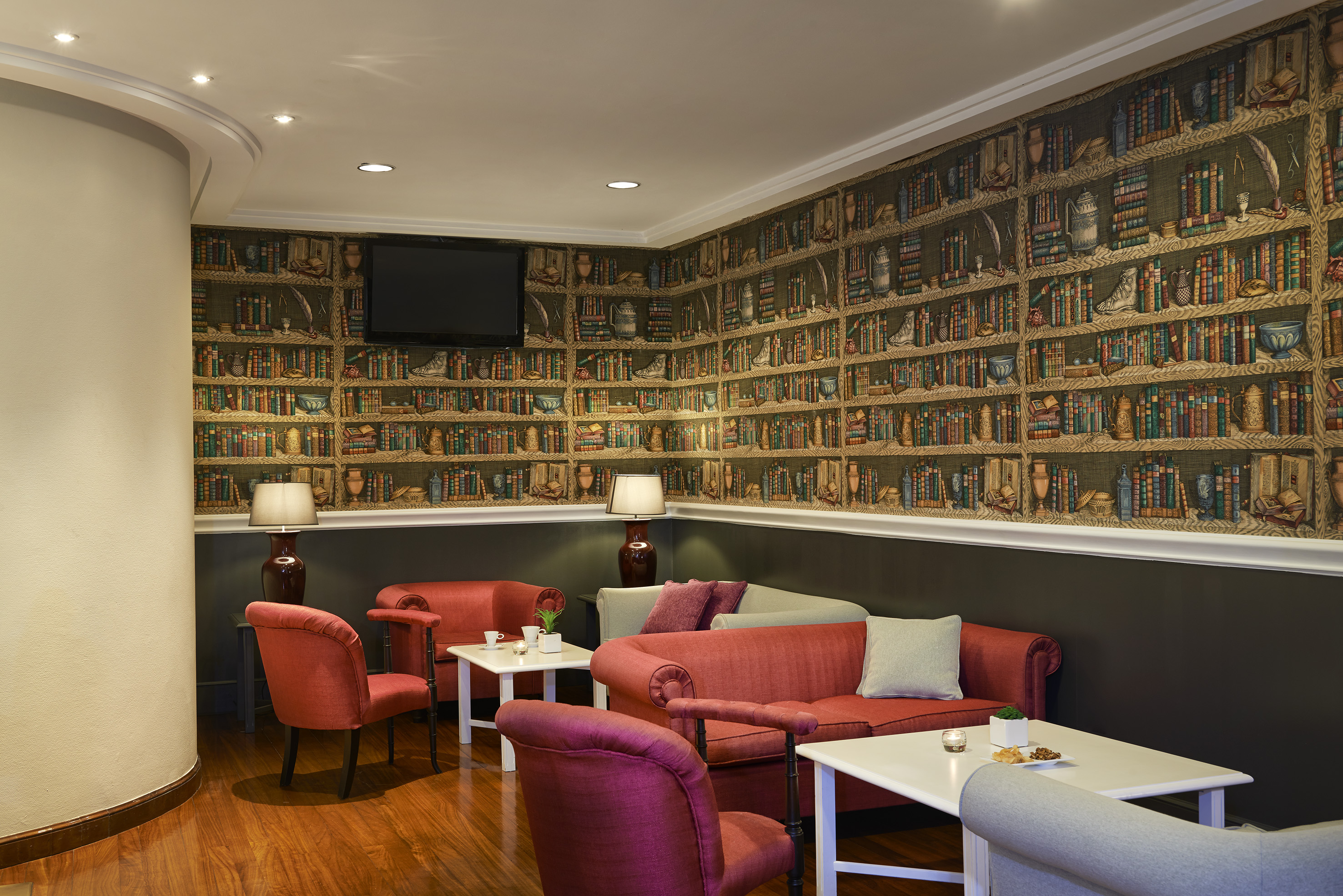 a room with a wall of books and a couch