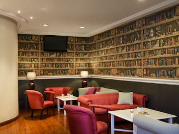 a room with a wall of books and a couch