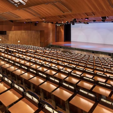 a large auditorium with rows of chairs and a stage