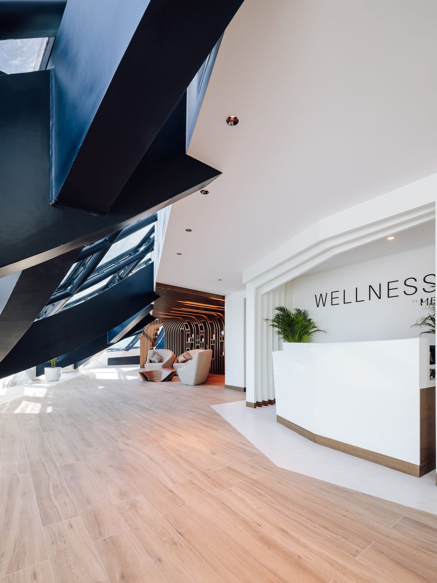 a lobby with a reception desk and a wood floor