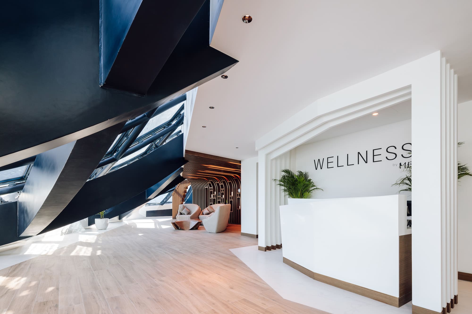 a lobby with a reception desk and a wood floor