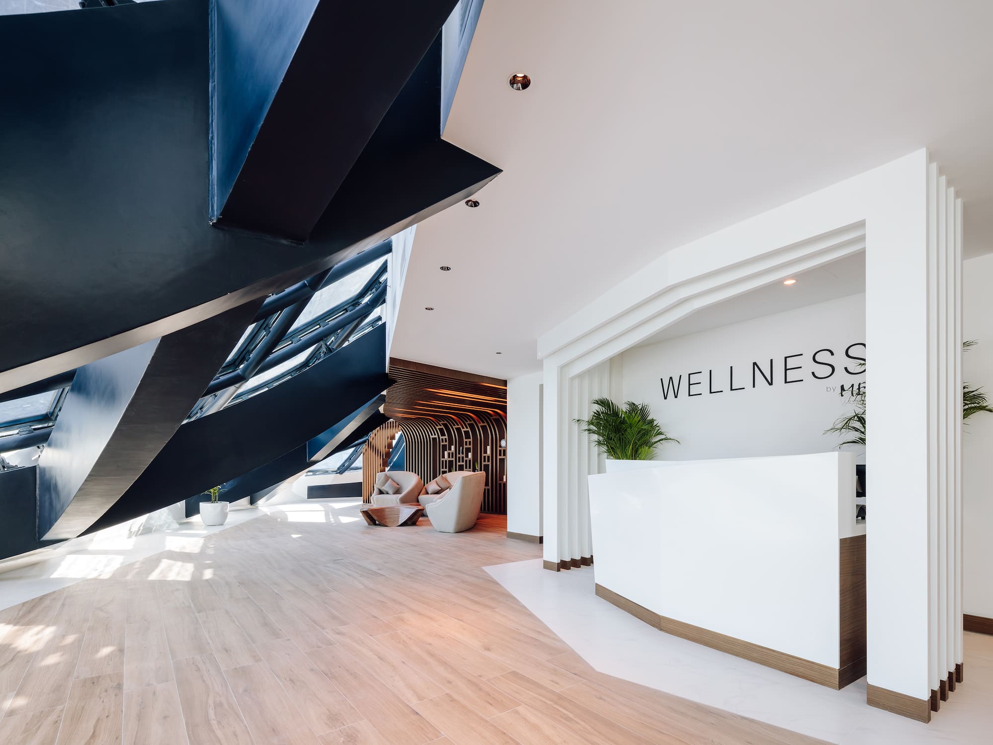 a lobby with a reception desk and a wood floor