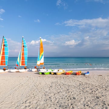 a group of sailboats on a beach