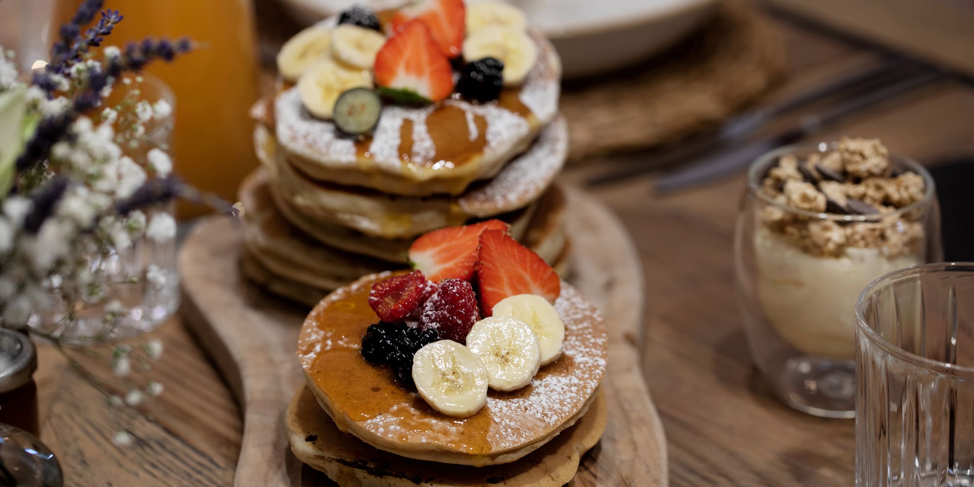 a stack of pancakes with fruit on top