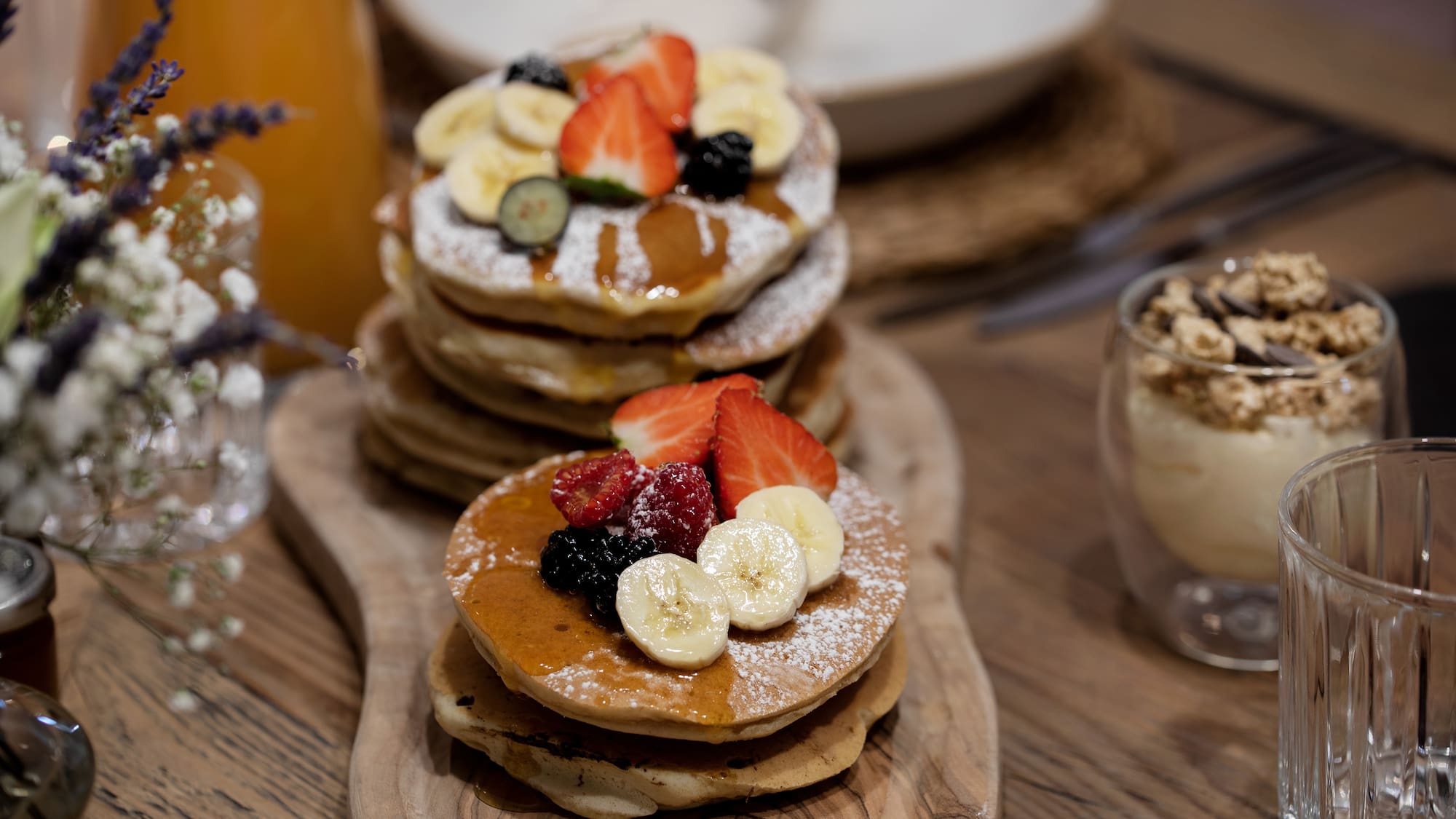 a stack of pancakes with fruit on top