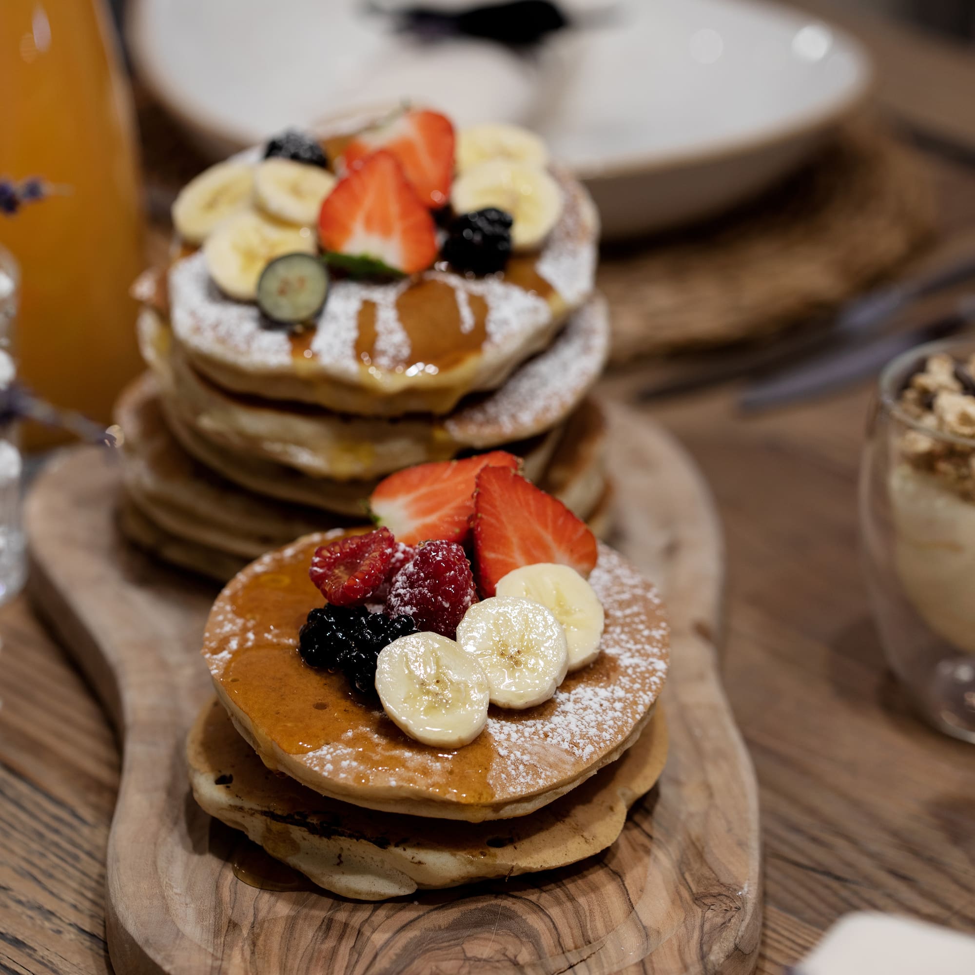 a stack of pancakes with fruit on top