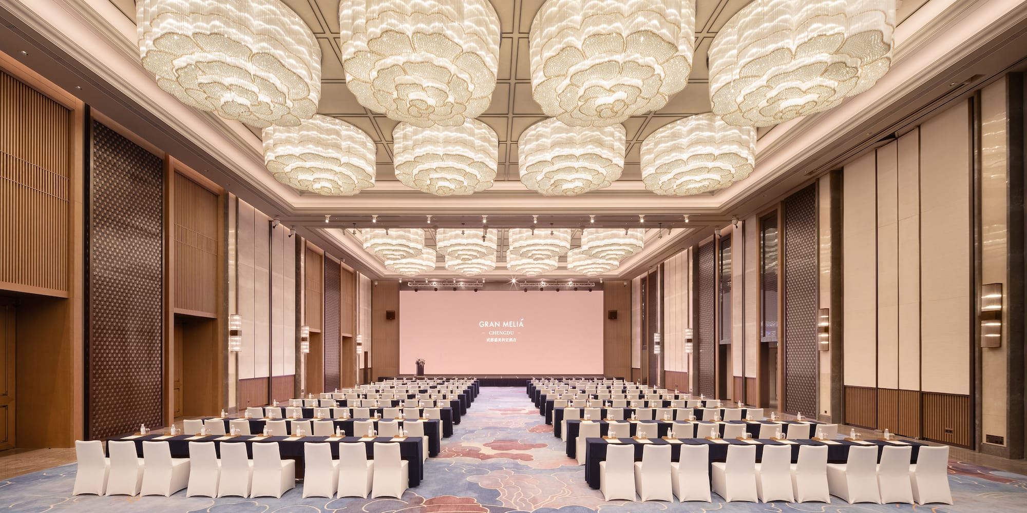 a room with chairs and a screen