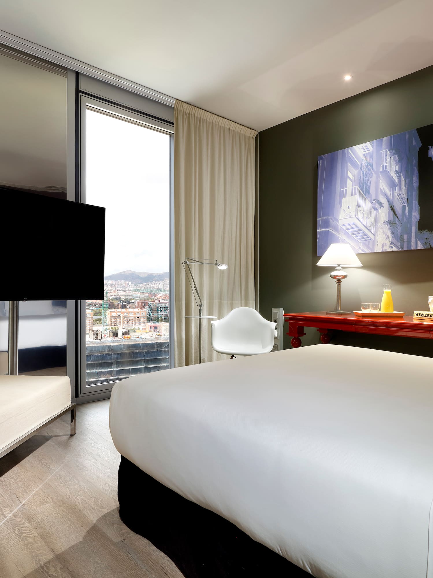 a room with a bed and a television