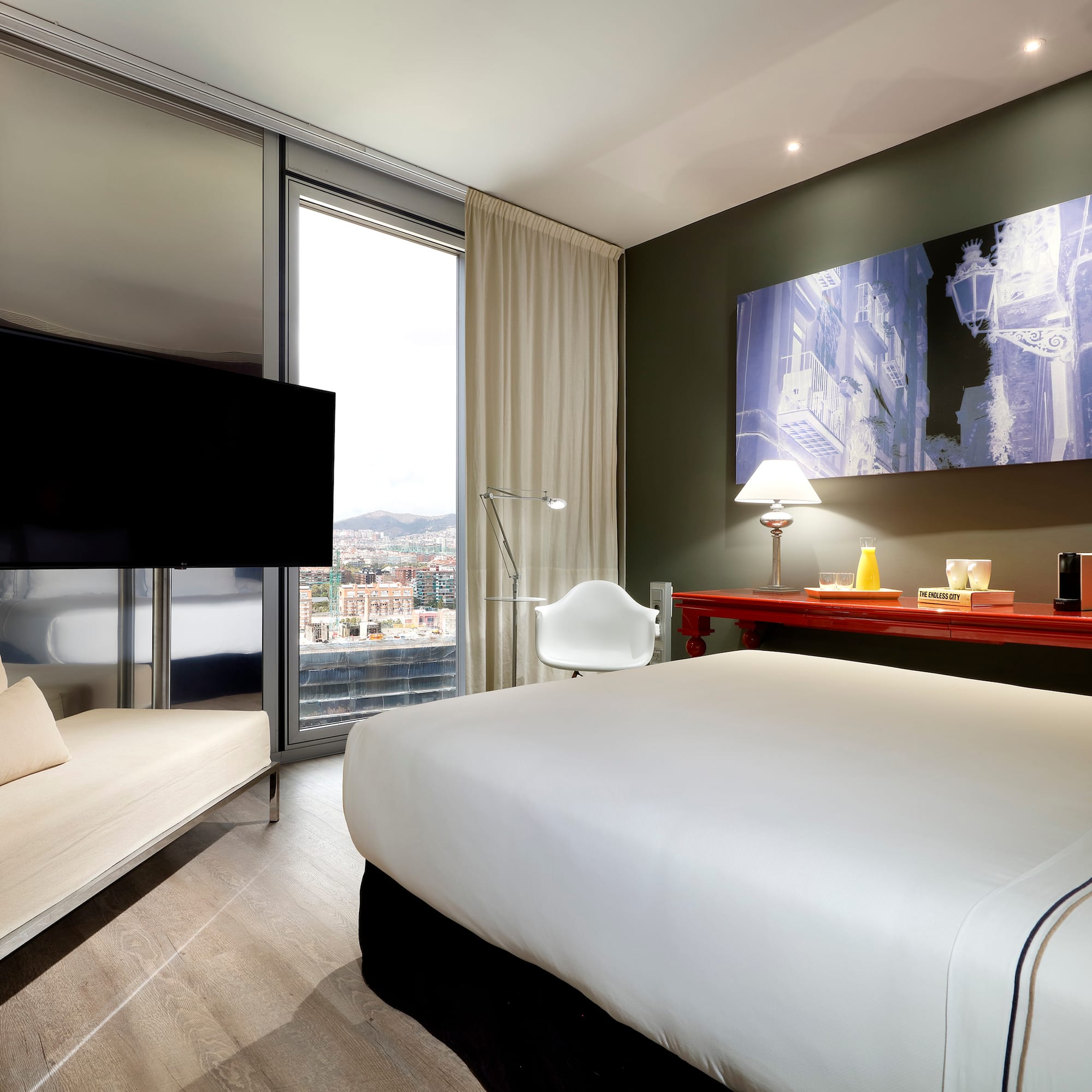 a room with a bed and a television