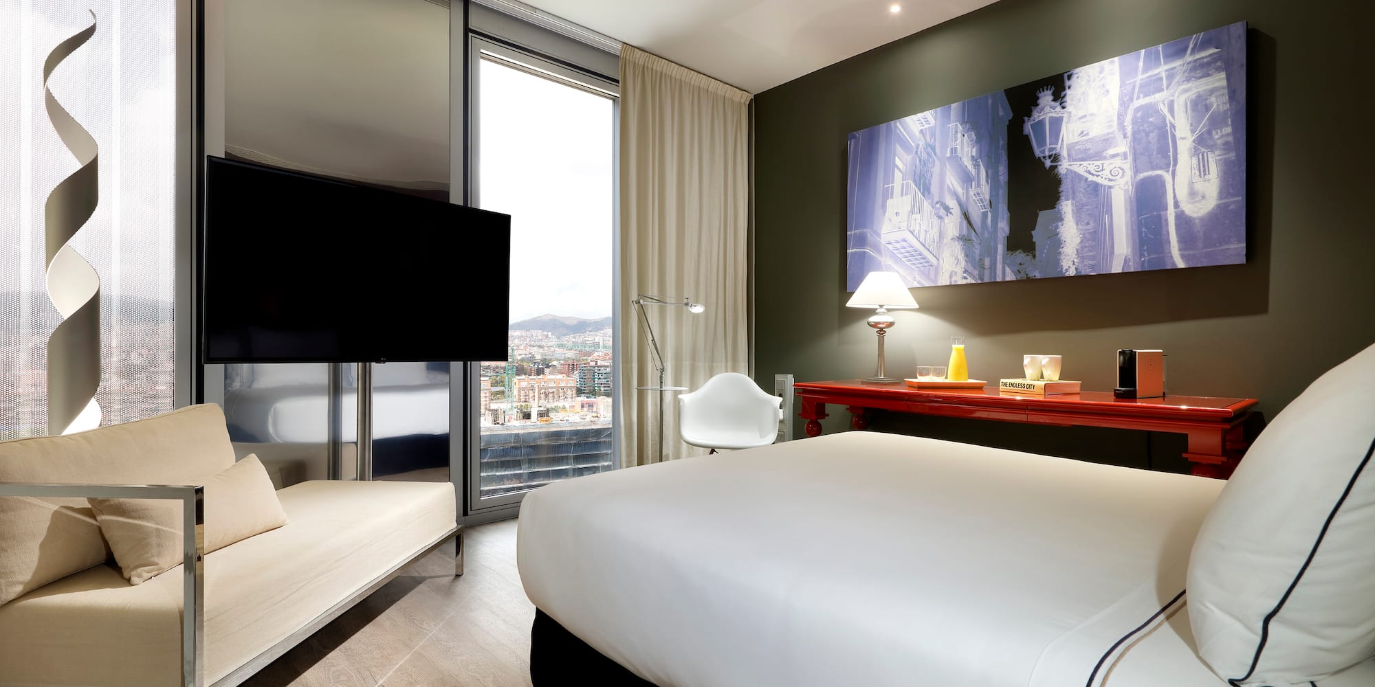 a room with a bed and a television