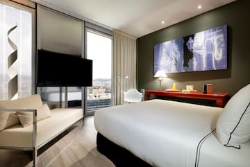 a room with a bed and a television