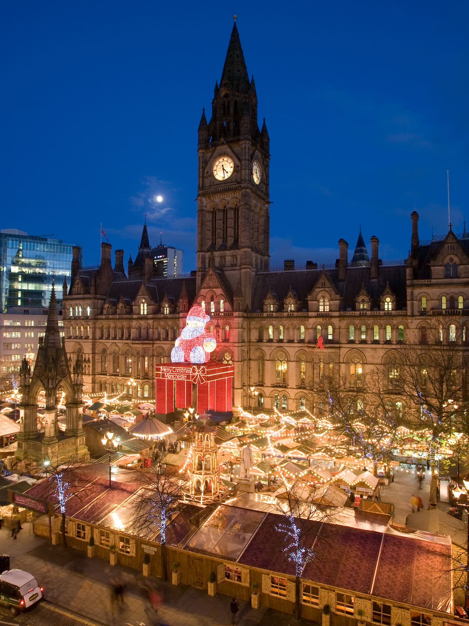 a large building with a clock tower and christmas lights