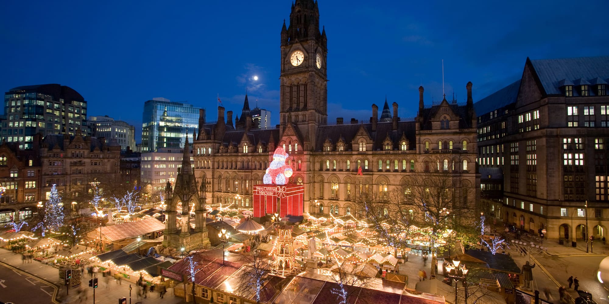 a large building with a clock tower and christmas lights